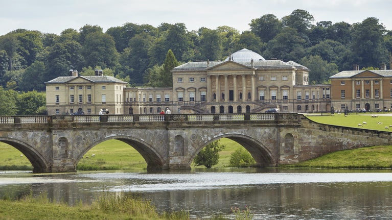 Kedleston Hall, Derbyshire with visitors on the bridge in the foreground